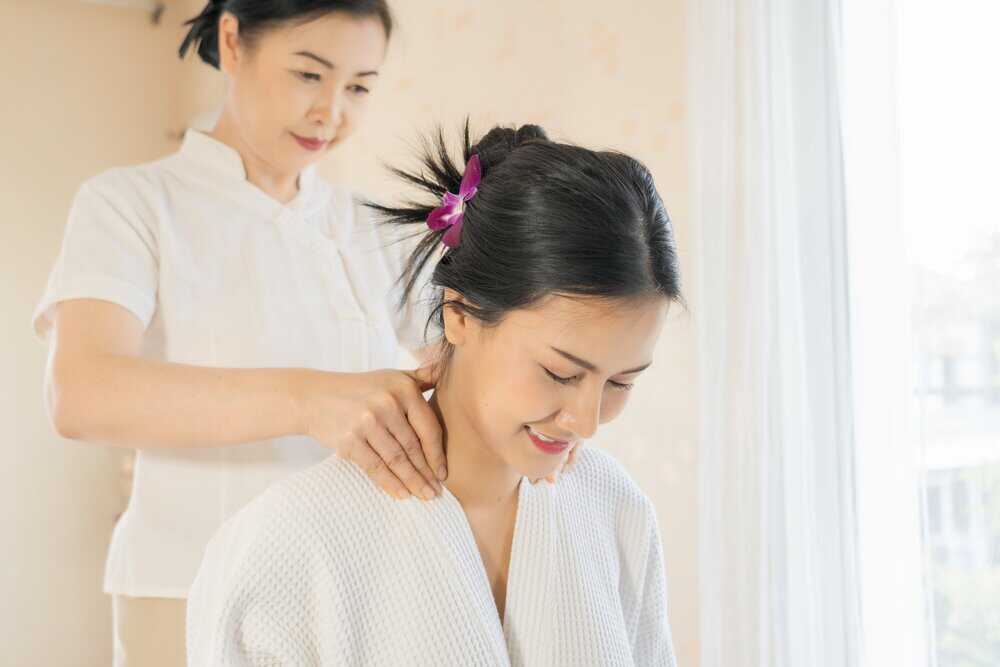 A woman enjoying neck and shoulder massage benefits