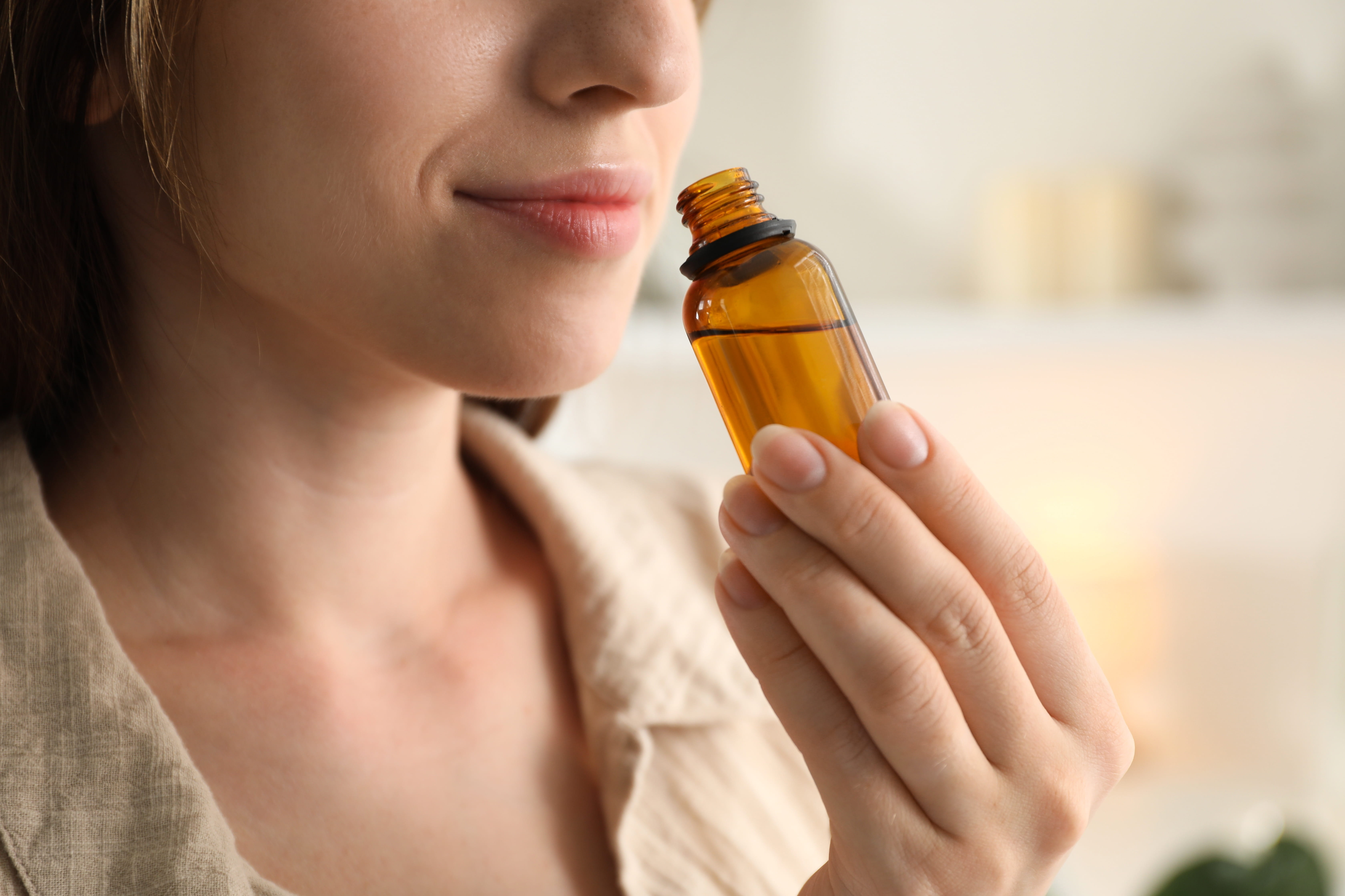 A woman inhaling essential oils to enhance mental focus and clarity