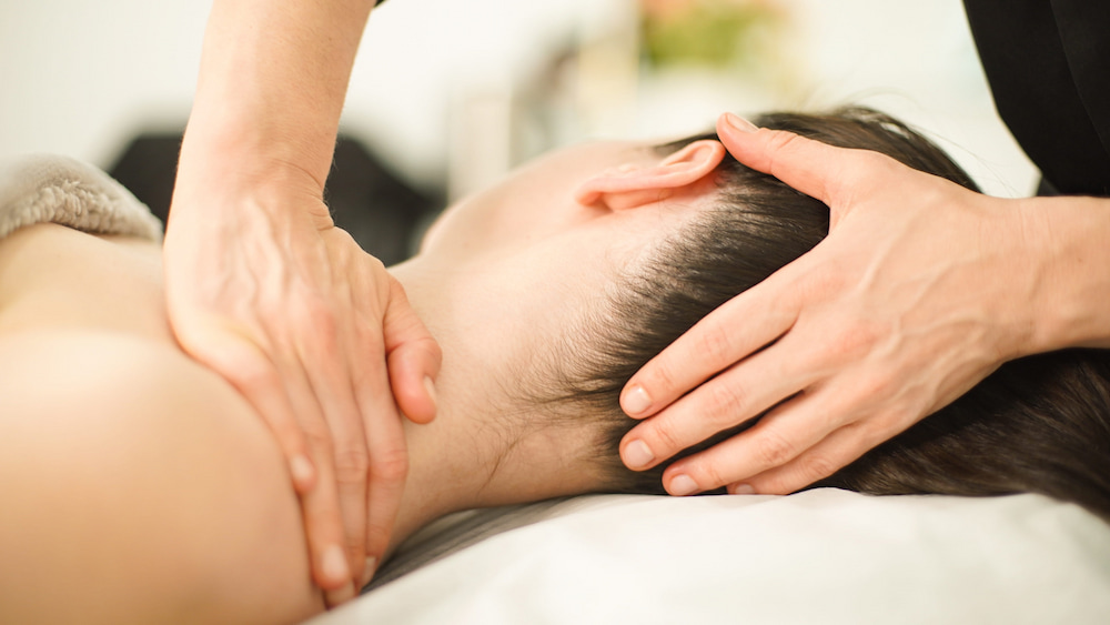 An office worker getting a quick lunch break massage to ease desk tension.