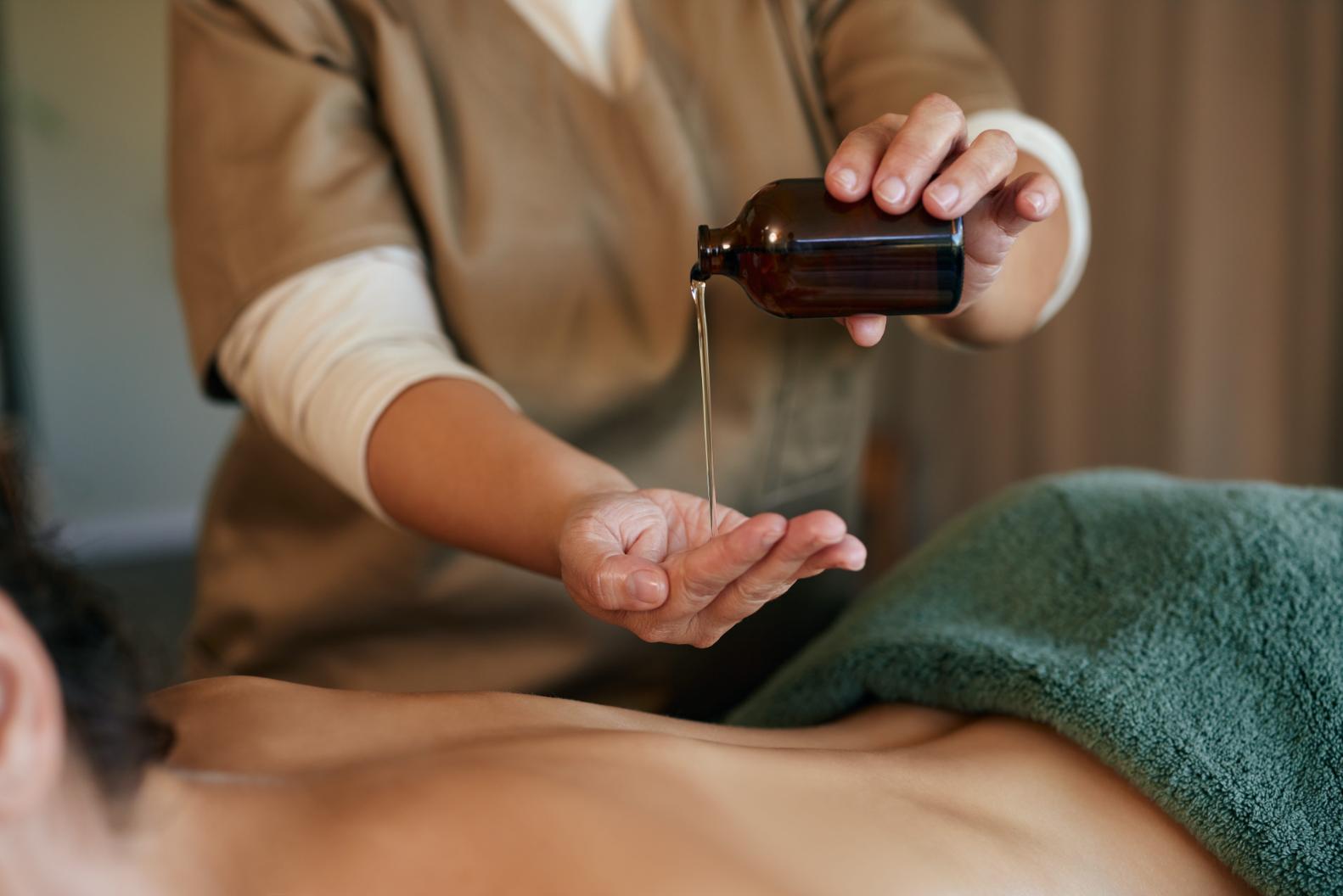 A woman having an aroma oil massage as one of the activities she does to reduce stress.