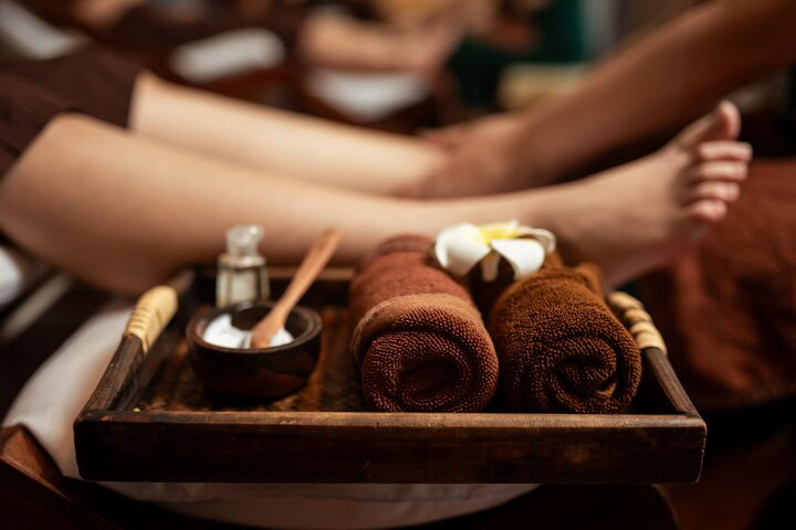 a basket with towels and lotion used in for giving a Thai foot massage