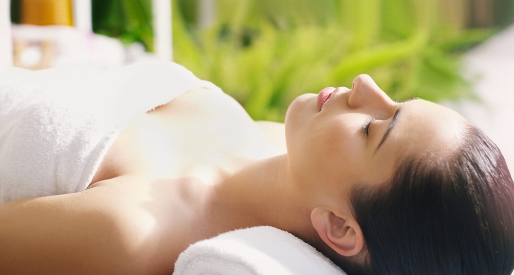 A woman relaxing in a spa before a treatment