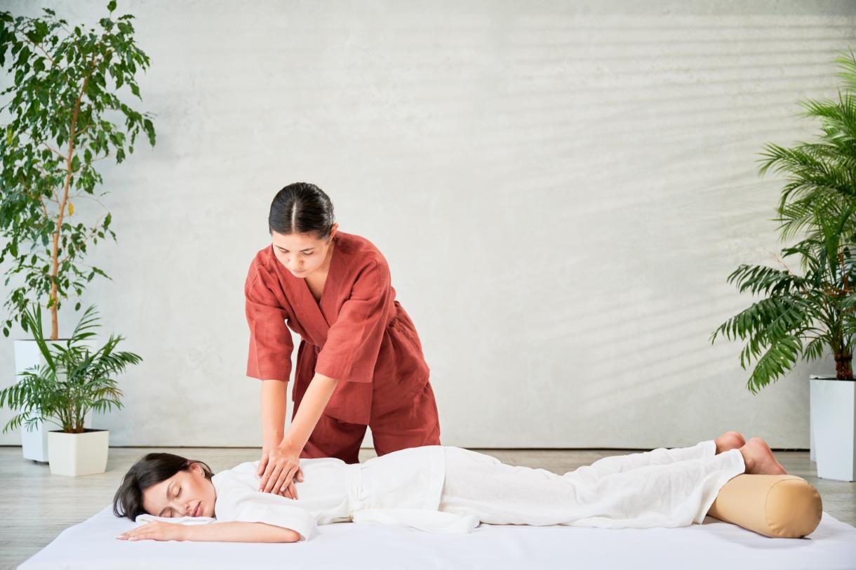 A woman getting massage therapy for office syndrome