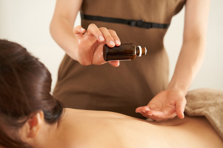 A therapist adds essential oils during a massage