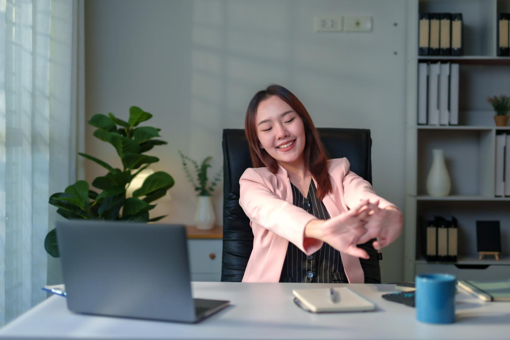 A woman relaxing after including an activity to reduce stress in the middle of her work day.
