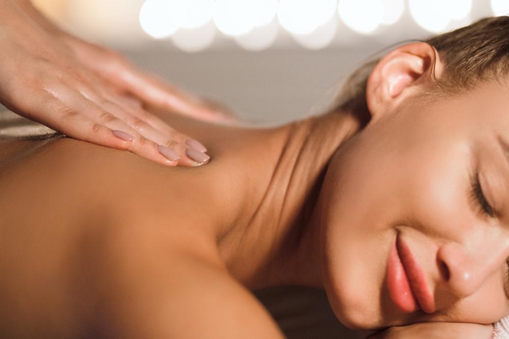 A relaxed guest falling asleep peacefully during a calming full-body massage.