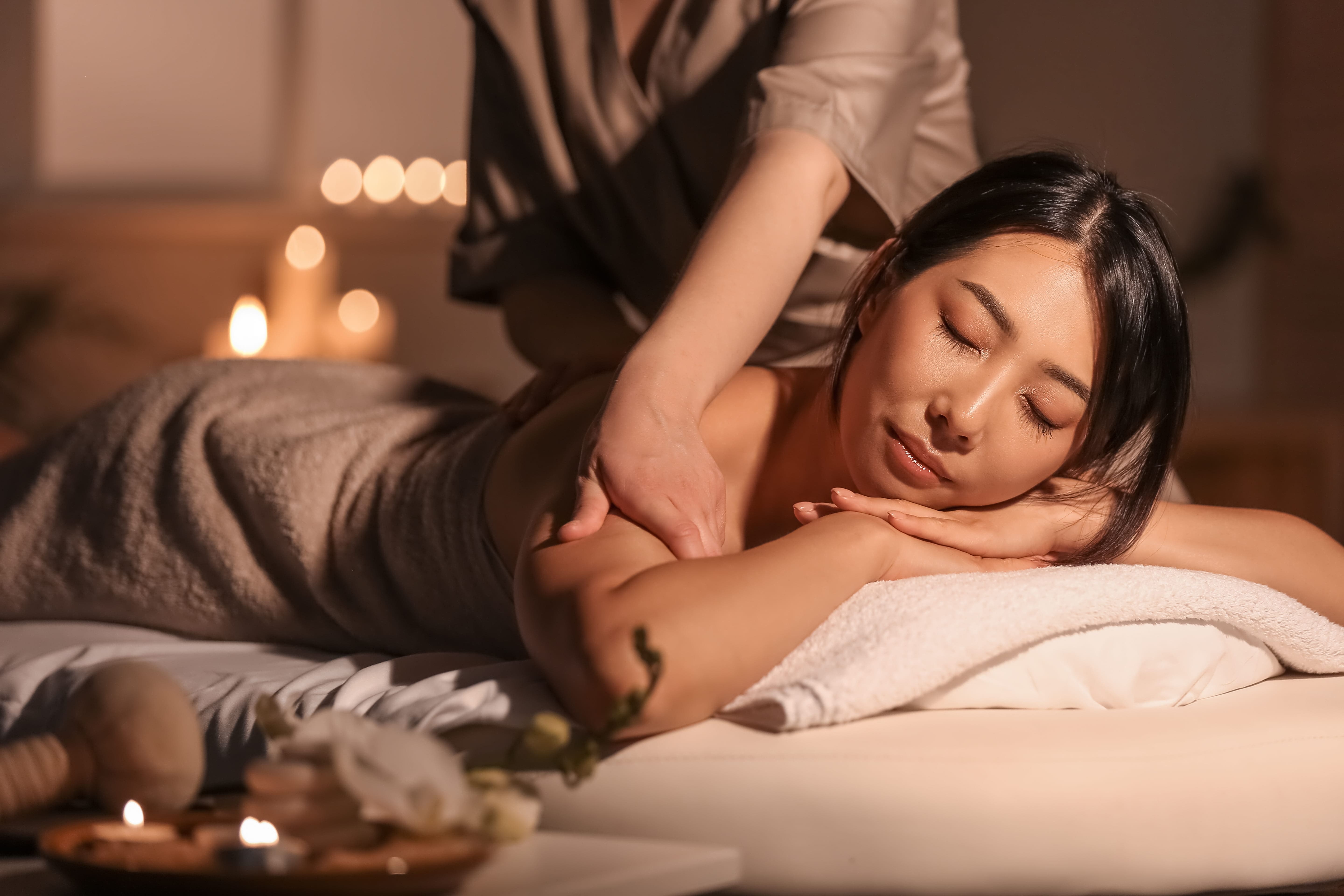 A guest relaxes during a calming session. The ideal massage frequency helps with stress management.