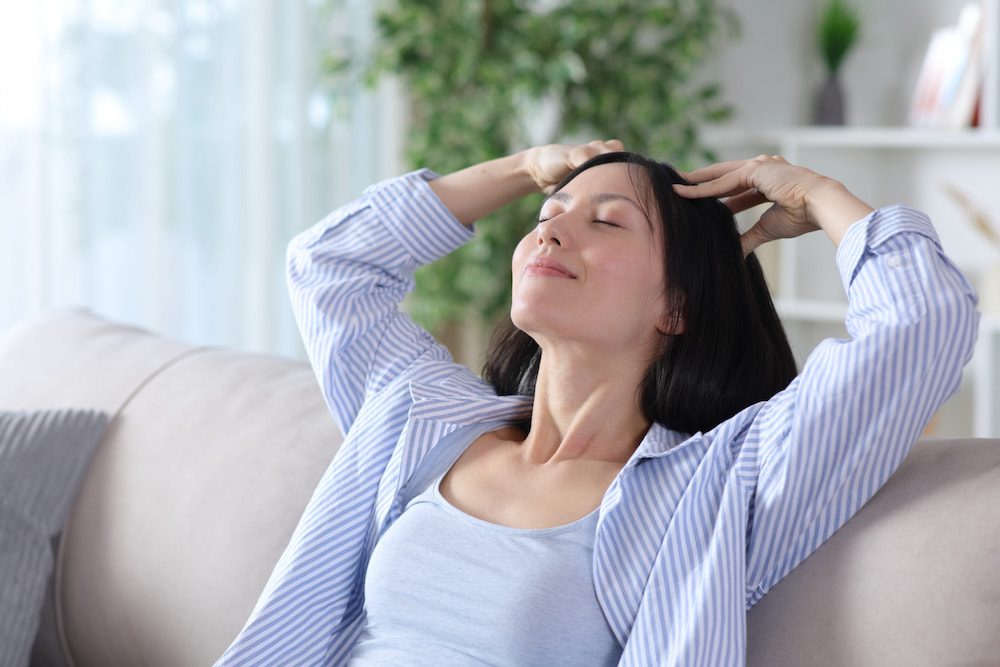 A person doing a self scalp massage at home to ease everyday tension.