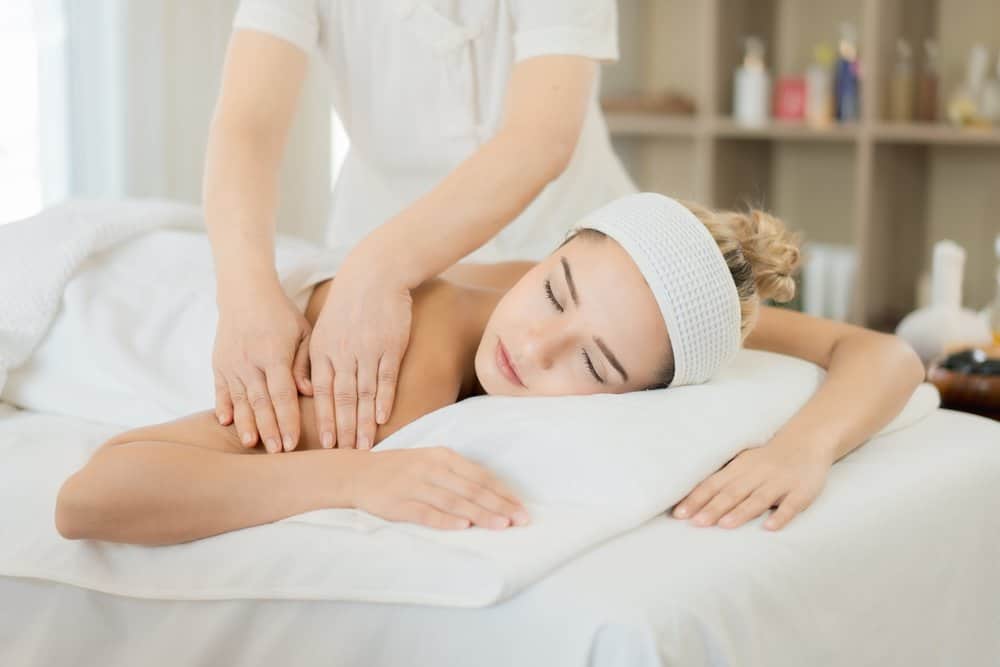 A woman relaxes while receiving a deep stretching massage