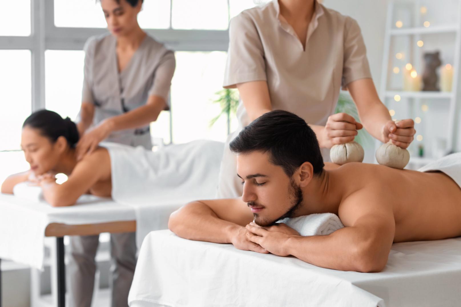 A tired couple relaxes during a massage after a long flight, part of tips to help get over jet lag.