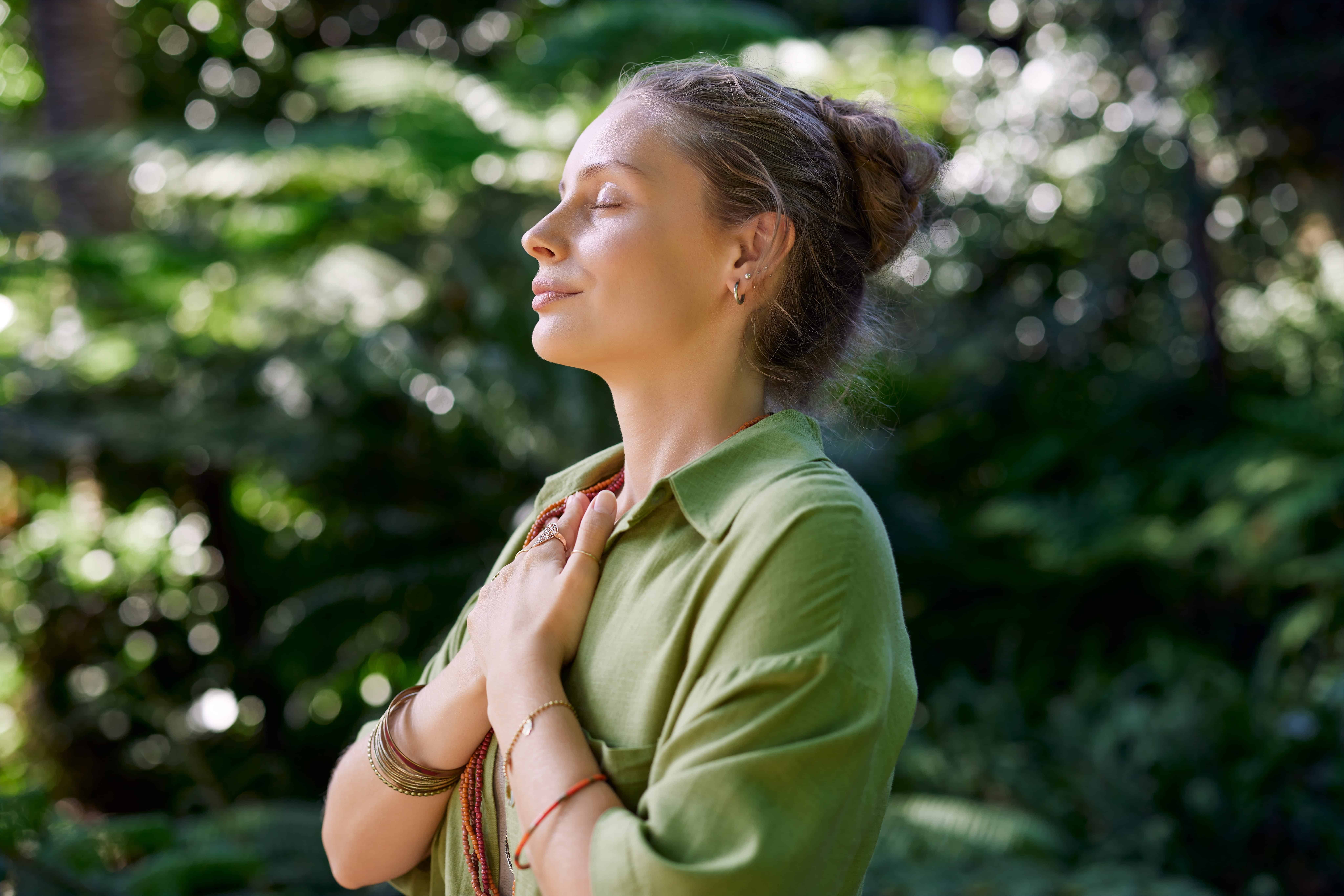 A woman doing mindful meditation as an act of self care