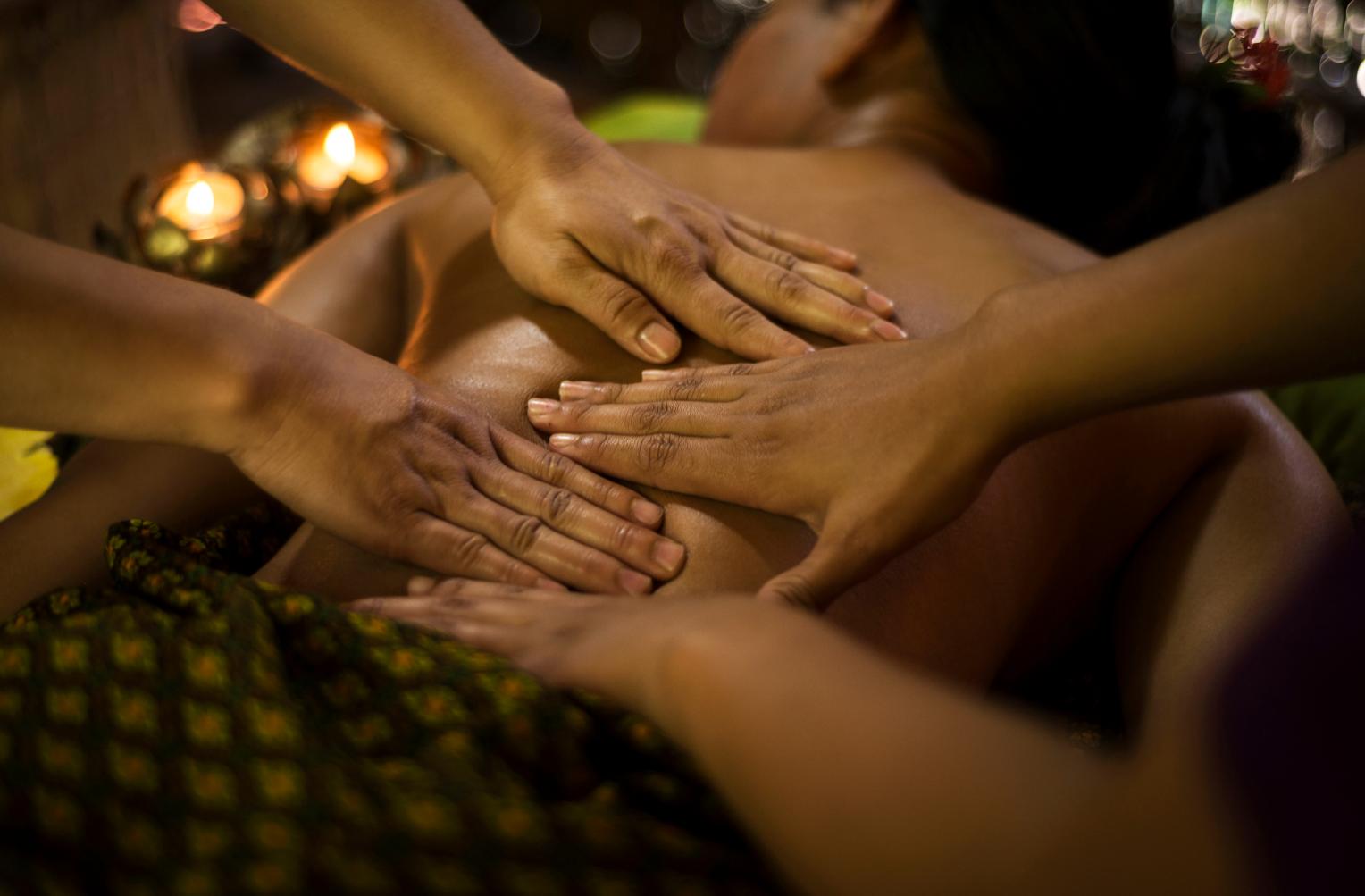 A four hands massage being performed